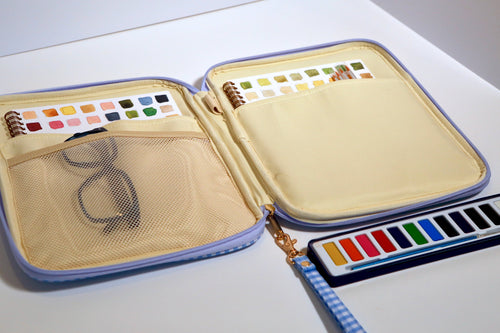 Juliette clutch — open with paints and workbook