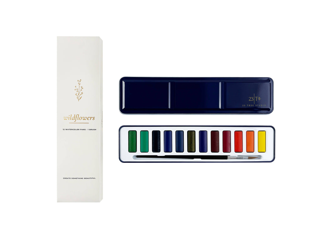 Wildflowers 12 watercolor set — printed gift box beside the open navy tin
